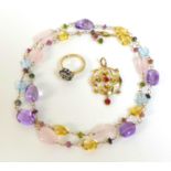 A 9ct gold gem set necklace, with rounded pieces of rose quartz, amethyst, topaz, and citrine,