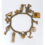 A 9ct gold charm bracelet, fitted with eleven 9ct gold charms and heart padlock clasp, comprising
