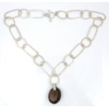 An interesting Modernist design silver necklace with large smokey quartz pendant, the chain of