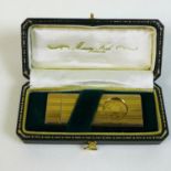 A gold plated cigar cutter in fitted case.