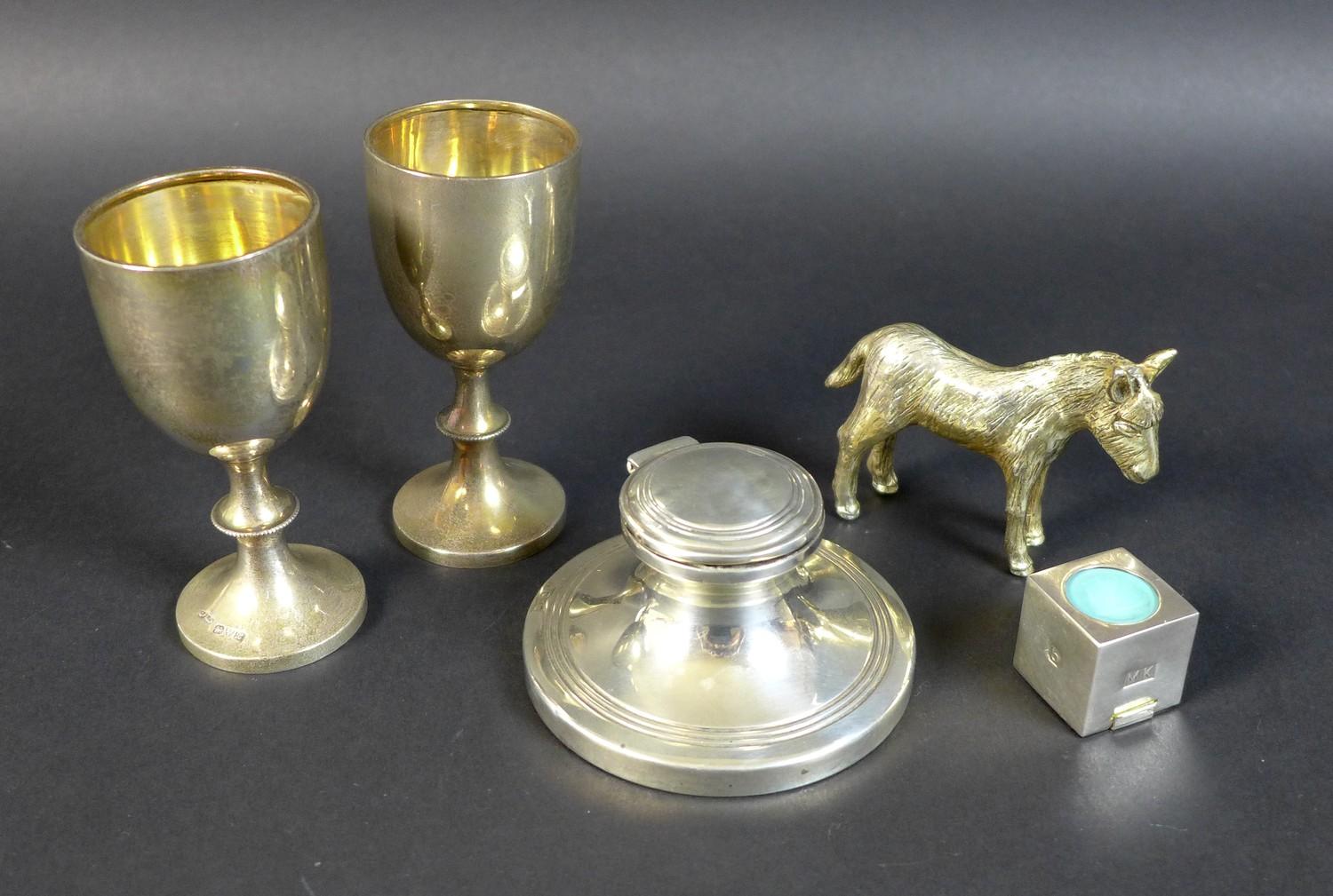 A group of four silver items, comprising a capstan inkwell, with hinged top, London 1917, makers