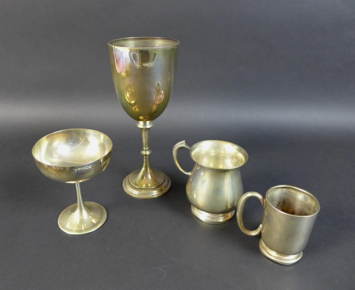 A group of silver cups and tankards comprising a Victorian Goblet of classic chalice form with