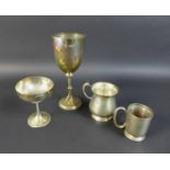 A group of silver cups and tankards comprising a Victorian Goblet of classic chalice form with