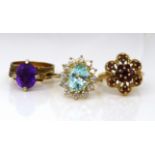 A group of three 9ct gold dress rings, comprising a garnet cluster ring, N/O, an aquamarine style