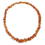 A string of vintage rough cut amber, with threaded amber bead screw clasp, 48cm long, 20g.