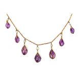 An Edwardian 14ct gold, amethyst and seed pearl necklace, with seven graduating amethyst drops