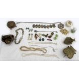 A small selection of costume jewellery, including clip on earrings, necklaces, and a purse filled