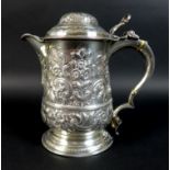 A George III silver stein with later fitted spout, the lid and main body with decorative repousse