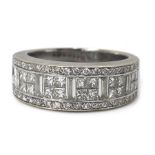 An 18ct white gold and diamond ring, in Art Deco style, circa 1990, with a wide band pave set with