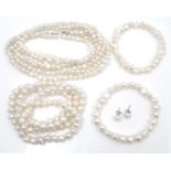 A collection of cultured pearl jewellery, comprising a freshwater pearl three strand necklace, two