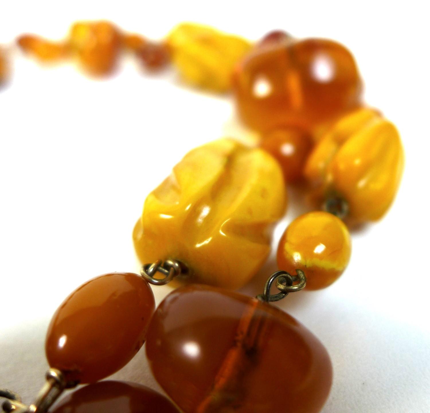 An amber necklace, with irregular form beads, including some butterscotch amber, 87cm long, gross - Image 3 of 3