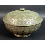 A South East Asian white metal bowl and cover, 19th century, with embossed decoration