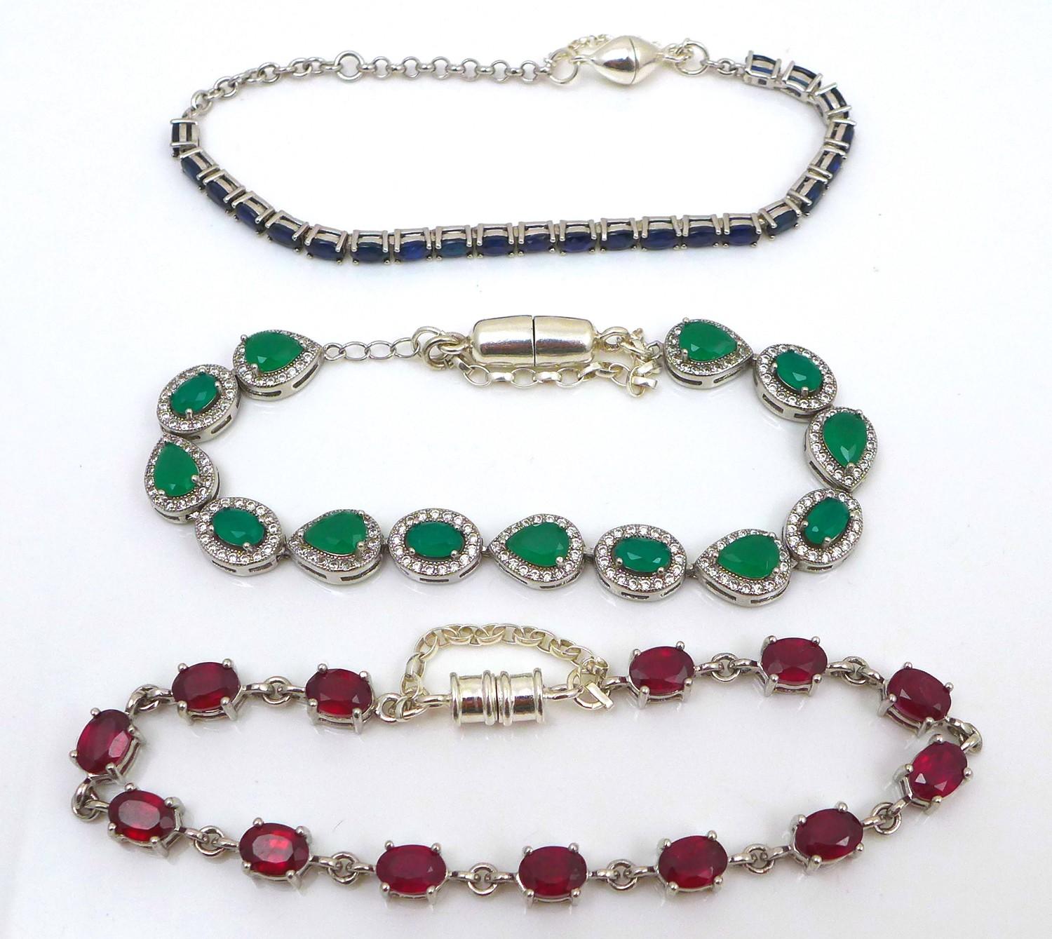 A group of three silver and gem set bracelets, comprising an emerald bracelet, set with thirteen