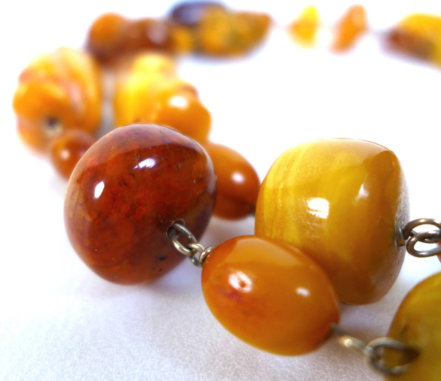 An amber necklace, with irregular form beads, including some butterscotch amber, 87cm long, gross - Image 2 of 3