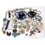 A collection of vintage costume jewellery and twelve wristwatches, including brooches, earrings, two