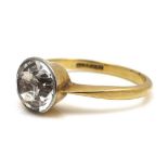 An 18ct gold and platinum solitaire ring, set with a brilliant cut white stone, possibly white