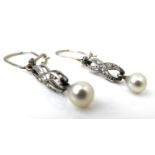 A pair of diamond and pearl drop earrings, set in 18ct white gold and platinum, in the form of a bow