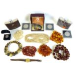 A collection of amber and costume jewellery including a necklace of rough cut butterscotch amber a