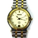 A Gucci 9000M stainless steel and gold plated wristwatch, circular ivory coloured dial with gold
