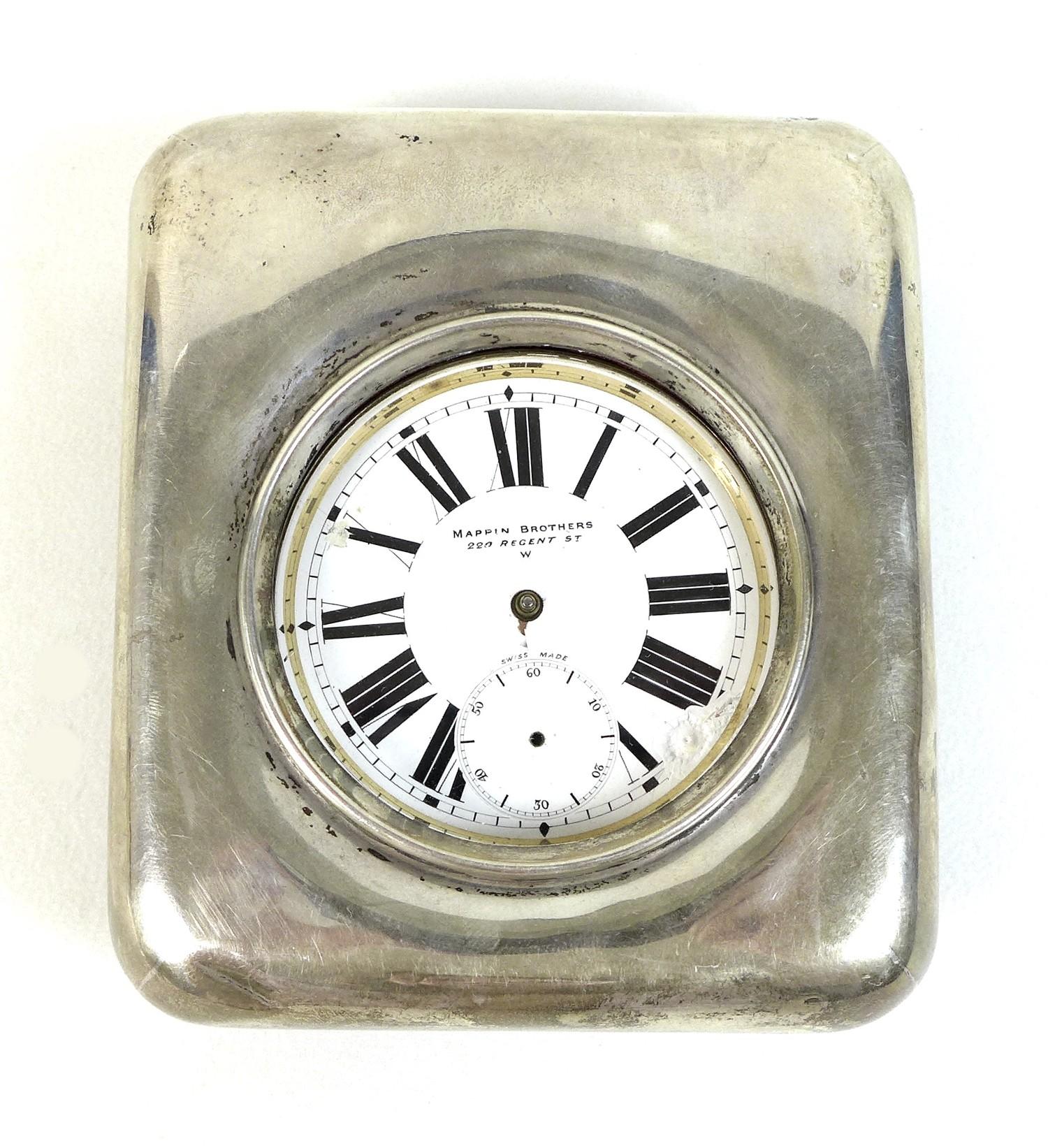 A late Victorian silver cased travel clock, with easel frame and silver front, containing an