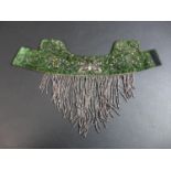 An Art Deco ladies choker, with white metal and sequin decoration upon a green velvet mount, white