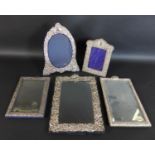 Three silver mounted table mirrors, all with blank cartouches, comprising of two Victorian