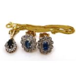 A 9ct gold sapphire and diamond necklace, the pendant with blue sapphire surrounded by illusion