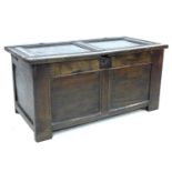 An early 18th century oak blanket chest, with two panelled front and top, loop hinges, stile feet,