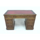 An Edwardian mahogany pedestal desk, with gilt tooled red leather top, 121 by 62 by 72cm high.