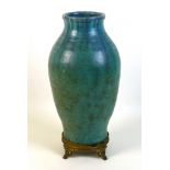 An Upchurch Pottery vase, circa 1930, of baluster form decorated in a blue green drip glaze, gilt