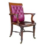A good Victorian mahogany office open armchair, with a purple buttoned leather back rest, shaped