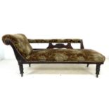 A late Victorian mahogany chaise longue, with carved frame, turned legs and castors, upholstered