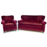 An Edwardian button back three seater sofa, together with a matching wing armchair, upholstered in