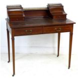 An Edwardian mahogany and line inlaid lady's writing desk, brass gallery and shelf between two