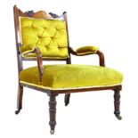 A late Victorian open armchair, with carved and inlaid frame, upholstered in green gold velvet,