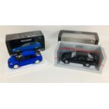 Two Minichamps 1:12 scale die-cast model Ford cars, a 2010 Ford Focus RS in blue, and a 1988 Ford