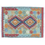 A vegetable dyed wool Choli Kelim rug, with pale blue ground with two central lozenges and geometric