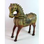 A 19th century carved wooden horse, with distressed hand painted colourful decoration, 53 by 18 by
