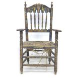 A Spanish painted rush seated open armchair, early 20th century, with shaped open arms and ladder