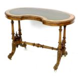 A Victorian walnut kidney shaped table, with amended turned supports and shaped legs with castors,