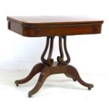A George IV mahogany, crossbanded and inlaid card table, the fold over surface inset with green