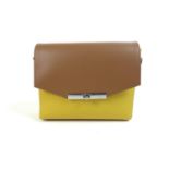A small Nicoli Italian leather handbag, in two-toned mustard and brown, with single handle,