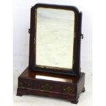 An early Georgian mahogany toilet mirror, the rectangular plate with moulded frame and gilt slip,