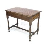An early 20th century stained pine and parquetry table, the rectangular inset surface over a