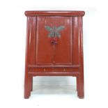 A modern Chinese style cabinet, of tapering form with red lacquered finish, brass butterfly shaped