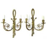 A pair of French gilt metal wall sconces, twin branch with scrolling decoration, each 31 by 15 by