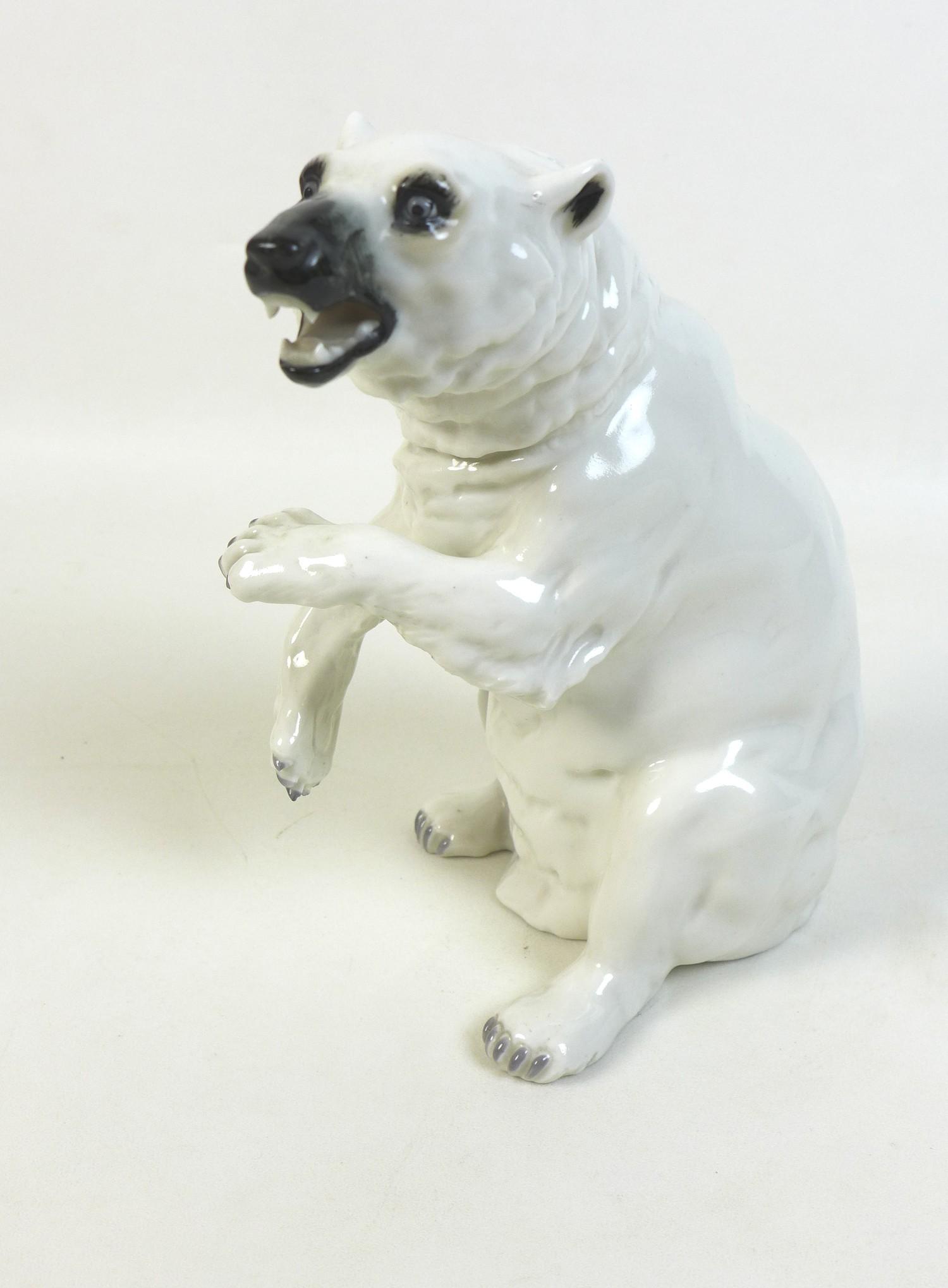 A 20th century Sitzendorf Polar bear figurine, the bear posed bearing teeth and rearing up from