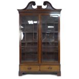 A Victorian mahogany bookcase, with line inlaid and crossbanded decoration, large pierced and carved