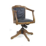 A vintage oak framed office swivel chair, circa 1930, with shaped arms, black leatherette seat and