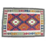 A Maimana Kelim rug, with red ground, two central lozenges and cream border, 122 by 83cm.